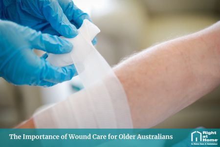 Registered nurse applying dressing and medical assistance to elderly person with a skin wound.